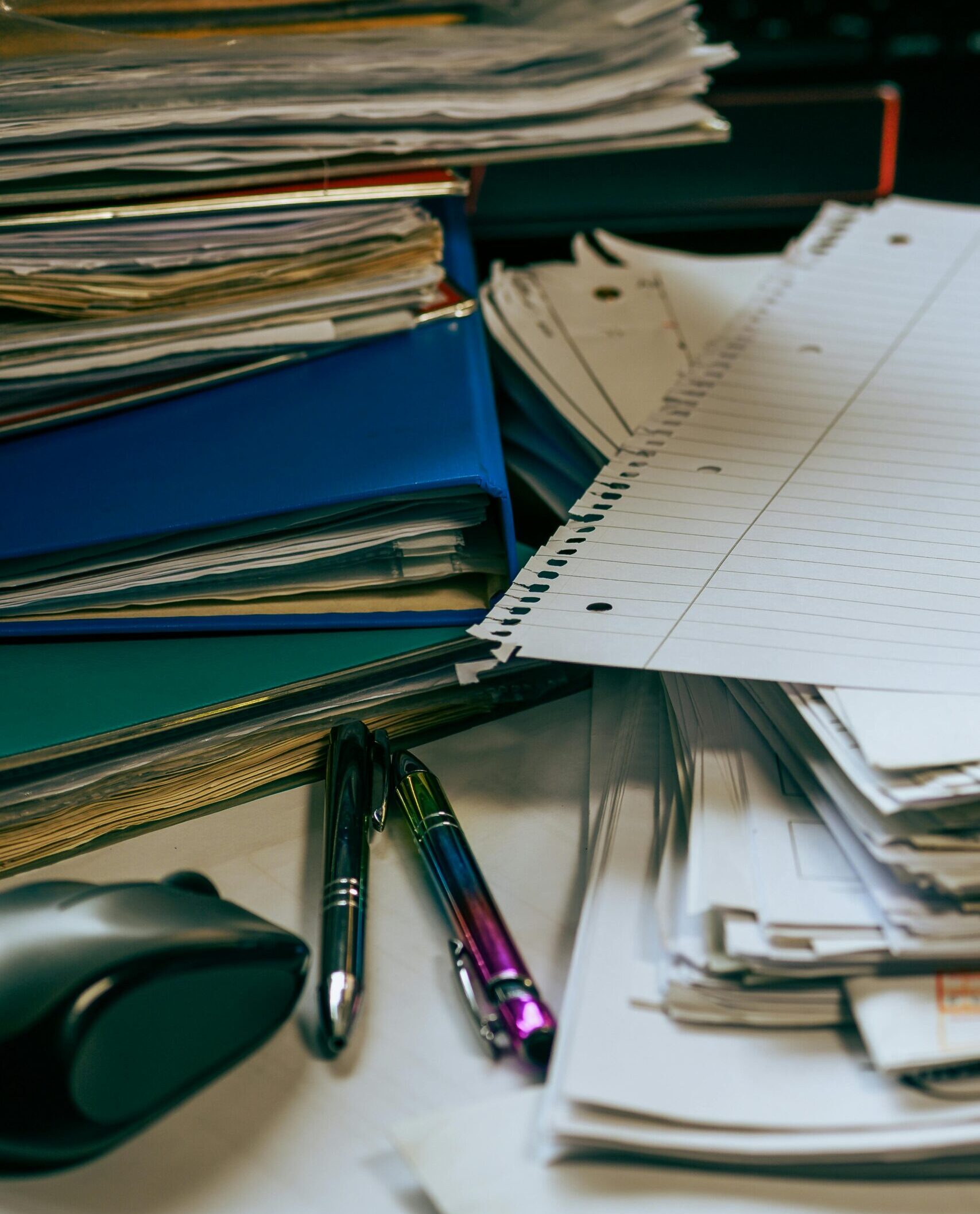 solutions for managing construction inefficiencies | How B3 Software can help Stack of disorganized paperwork obstructing solutions for managing construction inefficiencies