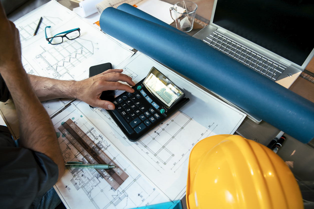 Calculating expenses for the house Pipes construction inventory on the construction site with rig in the background