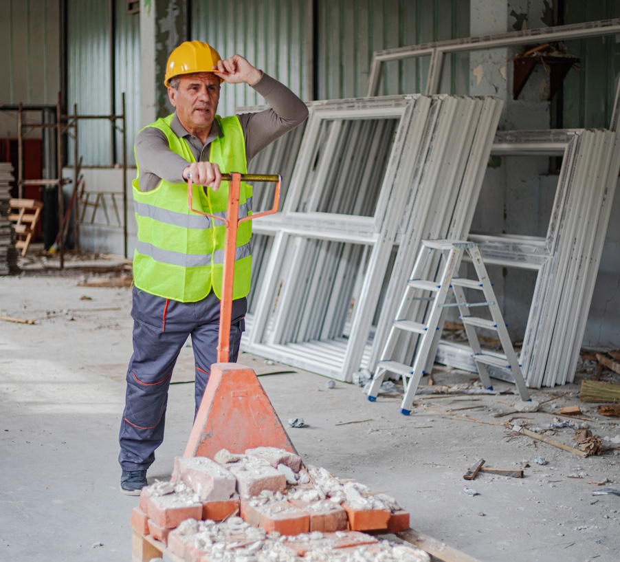 Inventory Management is key to thriving construction project management a construction man pushing a cart with very few bricks on it