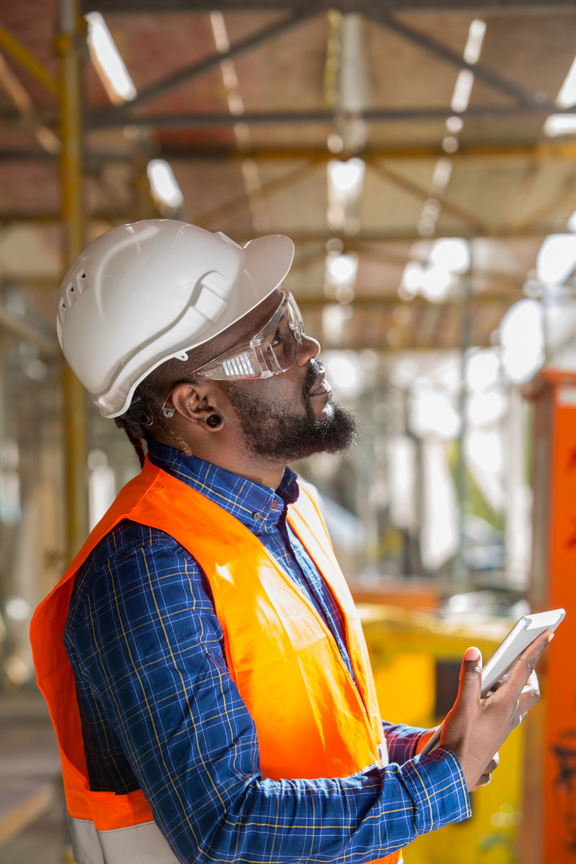 Profiled African american engineer at work using tablet computer